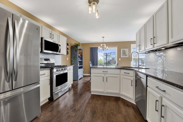 17412 Fox Bend Ln, Lockport, IL 60441 - kitchen featuring an inviting chandelier, a peninsula, a sink, dark wood finished floors, and stainless steel appliances