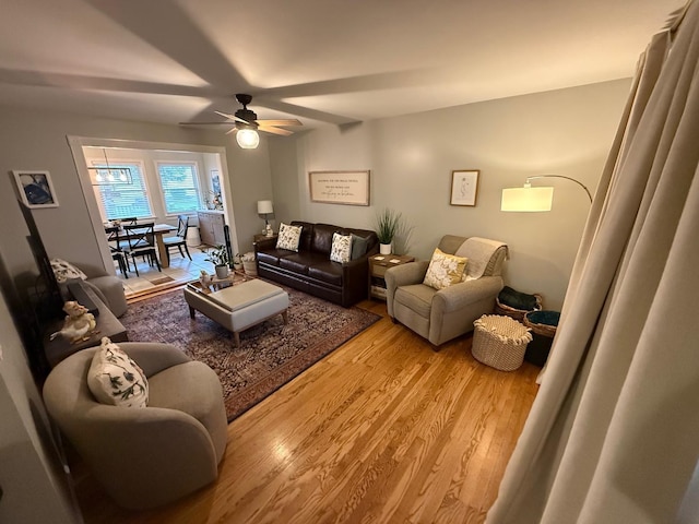 living area with light wood-style flooring and ceiling fan