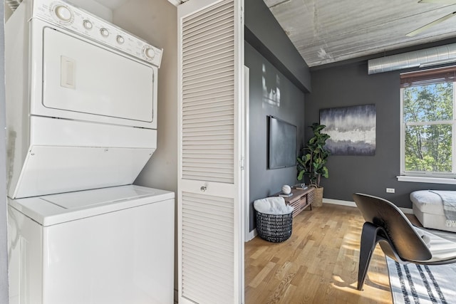 1228 W Monroe St Unit 301, Chicago, IL 60607 - clothes washing area with estacked washer and dryer, light wood finished floors, and baseboards