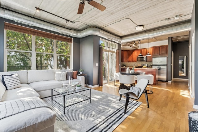 1228 W Monroe St Unit 301, Chicago, IL 60607 - living room featuring track lighting, light wood-type flooring, baseboards, and ceiling fan