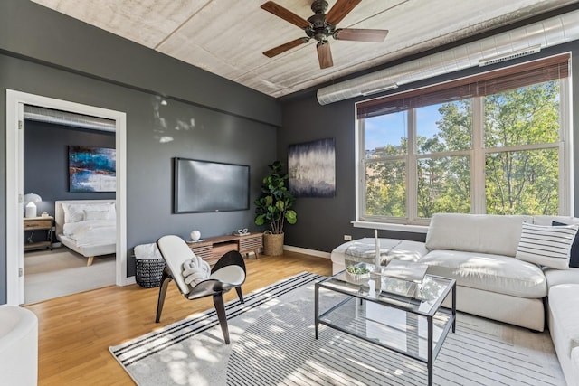 1228 W Monroe St Unit 301, Chicago, IL 60607 - living room featuring ceiling fan, wood finished floors, and baseboards