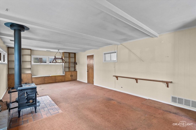 339 3rd St, Downers Grove, IL 60515 - unfurnished living room featuring a wood stove, carpet, visible vents, and beamed ceiling