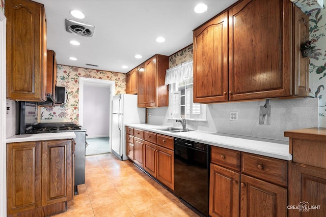 339 3rd St, Downers Grove, IL 60515 - kitchen featuring a sink, stainless steel range with gas stovetop, freestanding refrigerator, dishwasher, and wallpapered walls