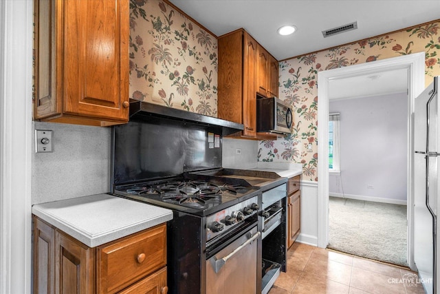 339 3rd St, Downers Grove, IL 60515 - kitchen featuring wallpapered walls, brown cabinetry, visible vents, and appliances with stainless steel finishes