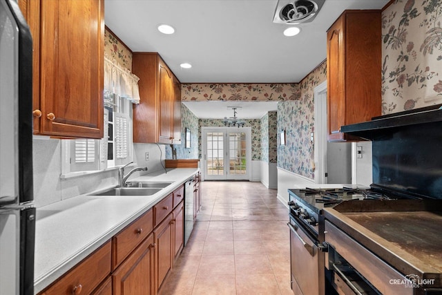 339 3rd St, Downers Grove, IL 60515 - kitchen featuring a sink, brown cabinets, wallpapered walls, and appliances with stainless steel finishes