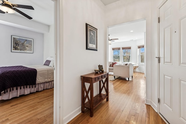 corridor with recessed lighting, baseboards, and light wood finished floors