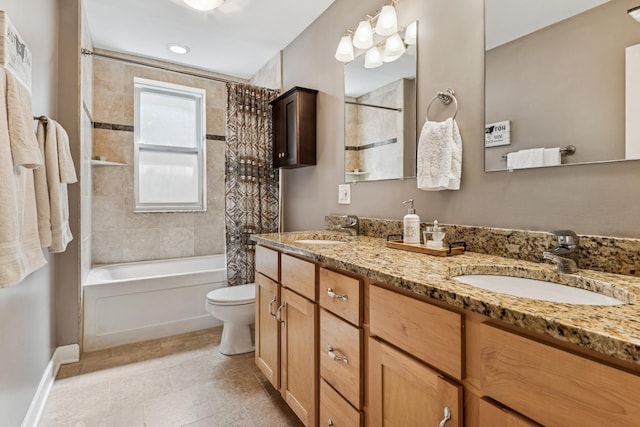 bathroom featuring double vanity, a sink, shower / tub combo, and toilet