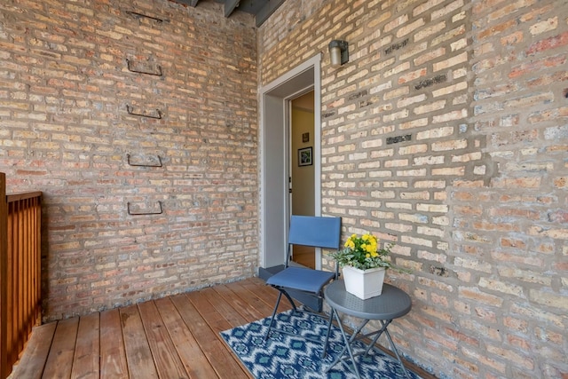 entrance to property featuring brick siding