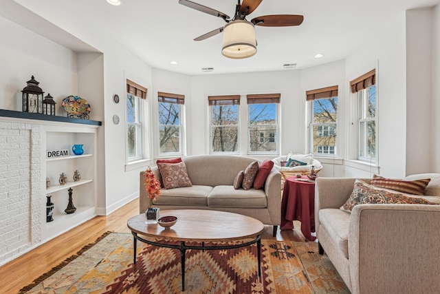 living room with baseboards, a ceiling fan, wood finished floors, and recessed lighting