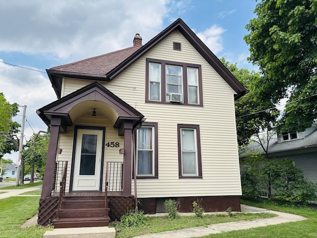 458 Morgan St, Elgin, IL 60123 - view of front facade with a front lawn and a chimney
