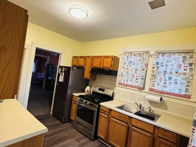 458 Morgan St, Elgin, IL 60123 - kitchen with stainless steel appliances, under cabinet range hood, light countertops, and brown cabinets