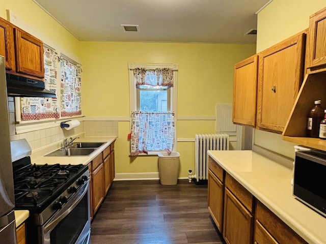 458 Morgan St, Elgin, IL 60123 - kitchen with radiator, stainless steel gas range oven, under cabinet range hood, dark wood-style floors, and light countertops