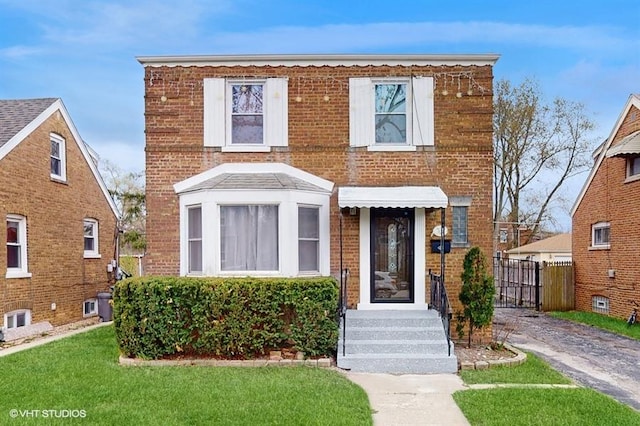 202 Hillcrest Ave, Chicago Heights, IL 60411 - view of front of property featuring brick siding, fence, and a front yard