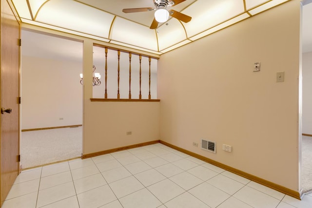 empty room featuring baseboards, visible vents, and ceiling fan