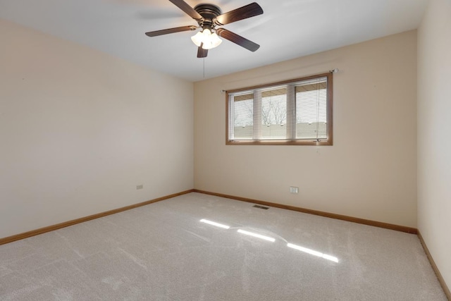 unfurnished room featuring baseboards, carpet, and ceiling fan