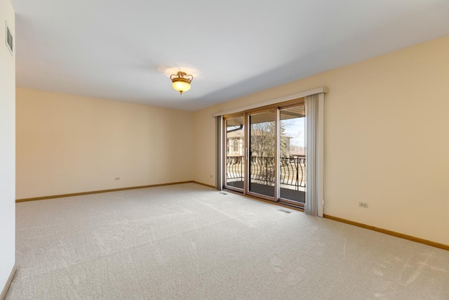 carpeted empty room featuring visible vents and baseboards