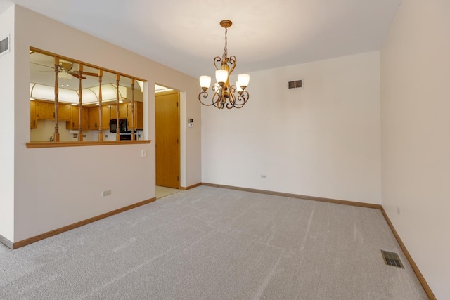 spare room featuring light colored carpet, visible vents, and ceiling fan with notable chandelier