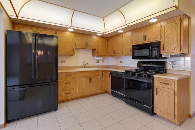 kitchen featuring a sink, black appliances, light countertops, backsplash, and recessed lighting