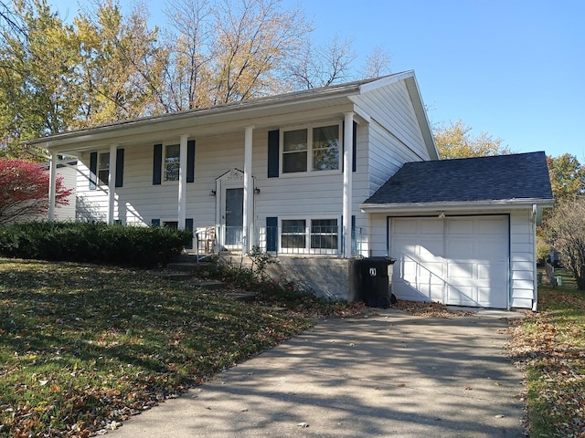 bi-level home featuring an attached garage and driveway