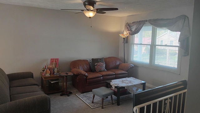 carpeted living area featuring a ceiling fan
