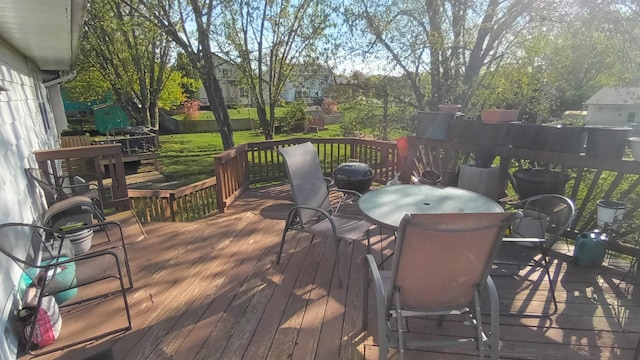 deck featuring a yard and outdoor dining area