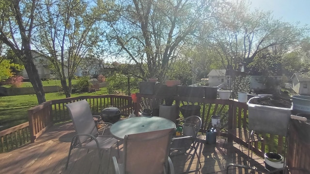 wooden deck featuring outdoor dining area and a grill