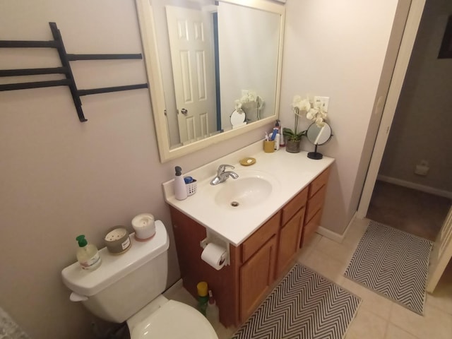 bathroom with vanity, tile patterned flooring, and toilet