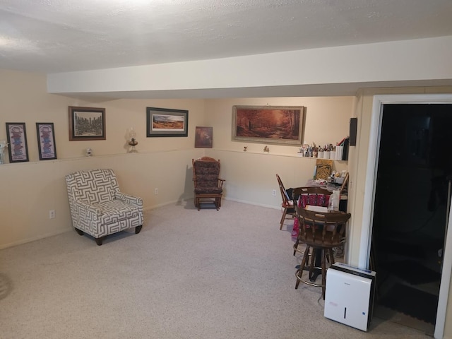sitting room featuring carpet floors and baseboards