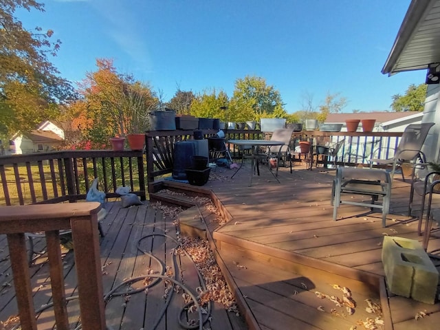 wooden deck featuring outdoor dining area