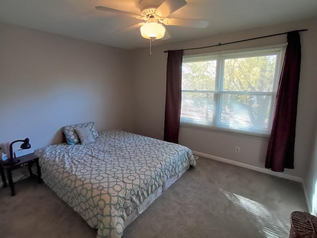 carpeted bedroom featuring a ceiling fan and baseboards