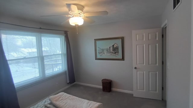 carpeted bedroom featuring visible vents, a ceiling fan, and baseboards