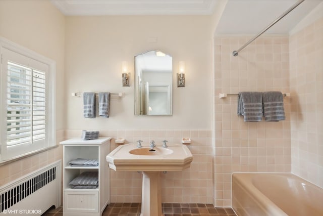 bathroom with tile walls, bathing tub / shower combination, a wainscoted wall, and radiator
