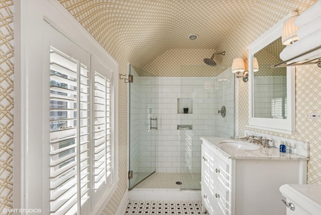 full bath featuring tile patterned floors, toilet, wallpapered walls, a shower stall, and vanity