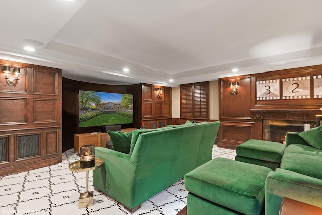 home theater room with recessed lighting and a warm lit fireplace