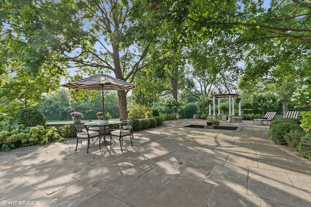 view of patio / terrace with a pergola and outdoor dining area