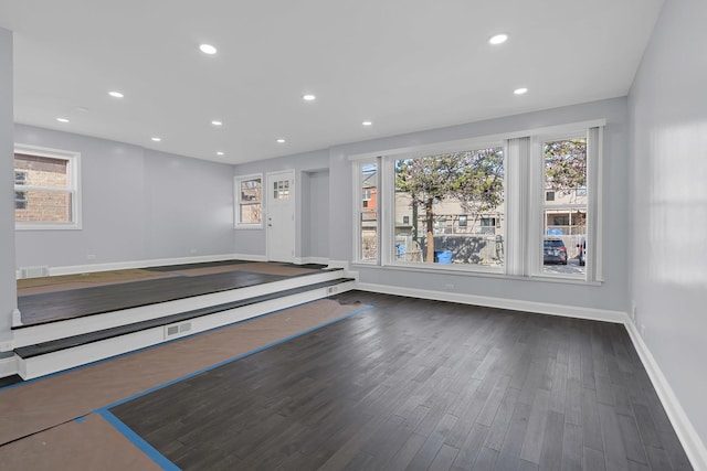 interior space with plenty of natural light, wood finished floors, baseboards, and recessed lighting