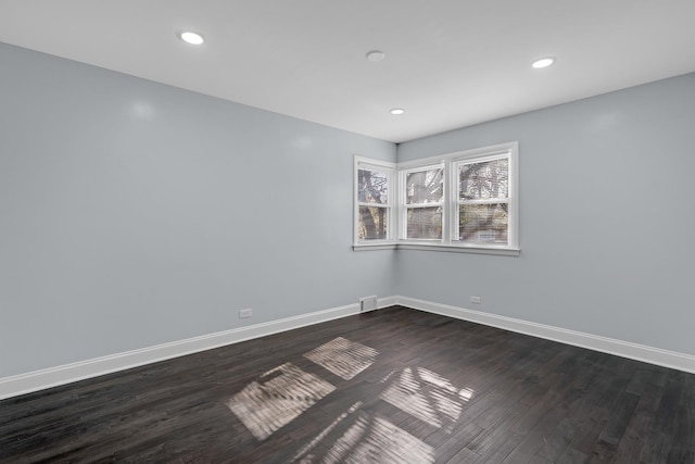 unfurnished room featuring baseboards, recessed lighting, and dark wood-style floors