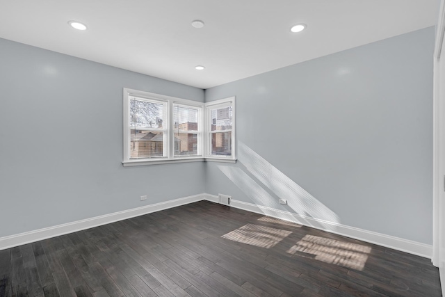 unfurnished room with visible vents, baseboards, recessed lighting, and dark wood-style flooring