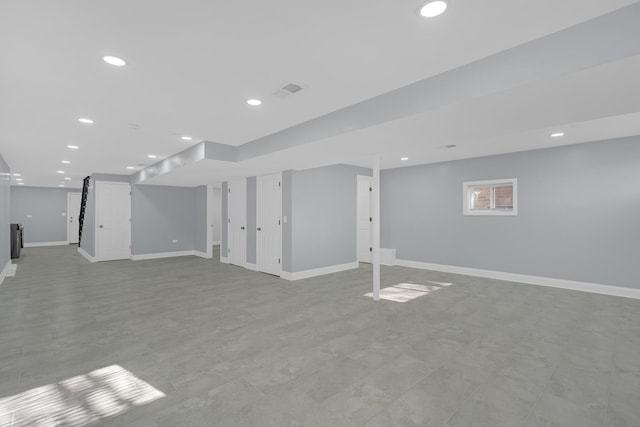 finished basement featuring baseboards and recessed lighting