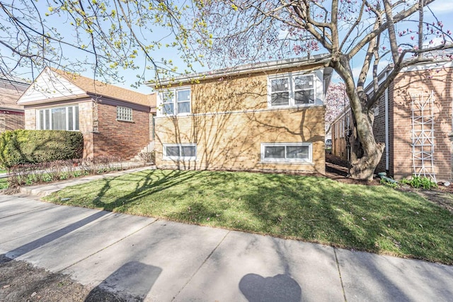 view of front of house with brick siding and a front yard
