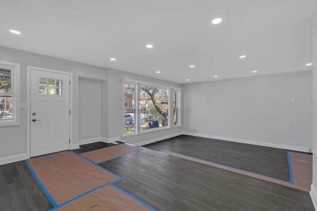 foyer entrance with baseboards, wood finished floors, and recessed lighting