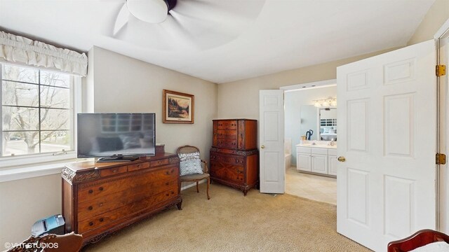 sitting room featuring ceiling fan and light carpet