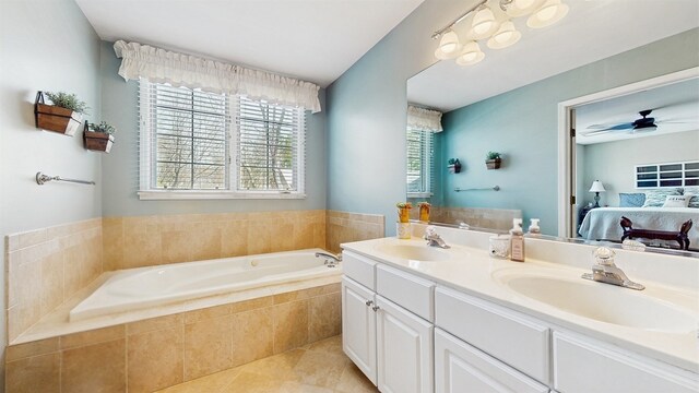 bathroom with a garden tub, a sink, ensuite bath, and tile patterned flooring