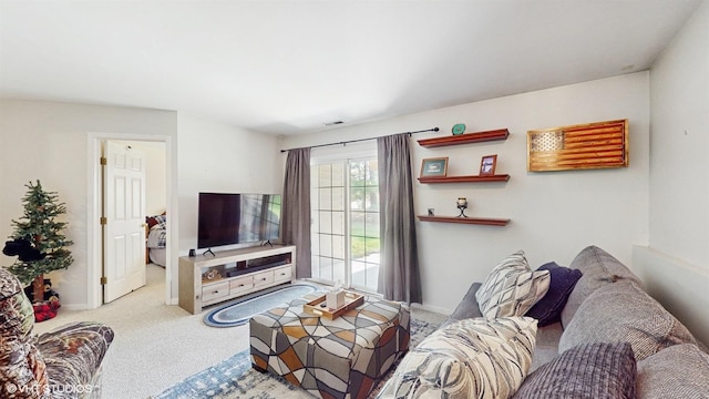 living area featuring carpet floors, baseboards, and visible vents