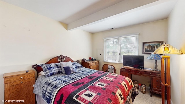 bedroom featuring visible vents, carpet flooring, and beam ceiling