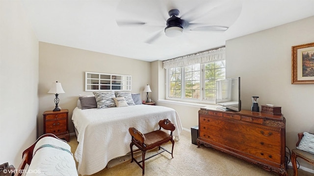 bedroom featuring a ceiling fan and light carpet