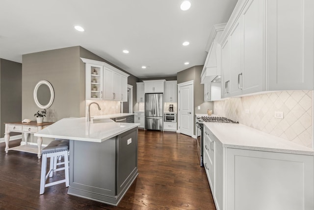 633 Bourbon Ct, Naperville, IL 60565 - kitchen featuring a peninsula, white cabinetry, decorative backsplash, light countertops, and appliances with stainless steel finishes