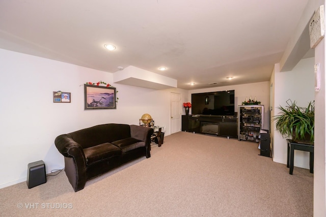 carpeted living area featuring baseboards and recessed lighting