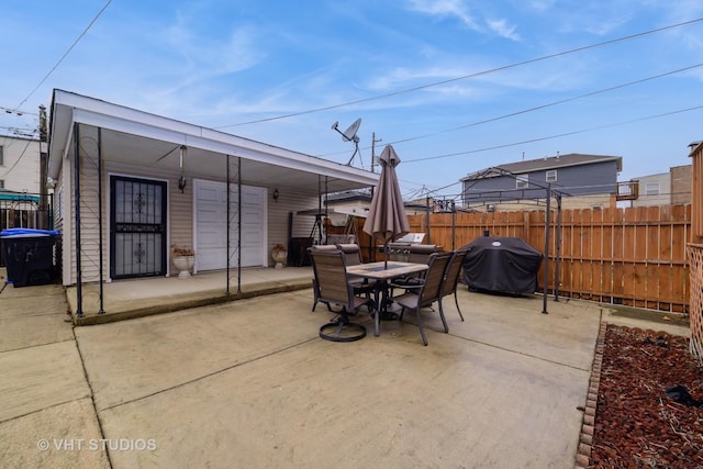 view of patio with grilling area, fence, and outdoor dining area