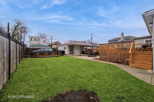 view of yard with a fenced backyard, a wooden deck, and a patio